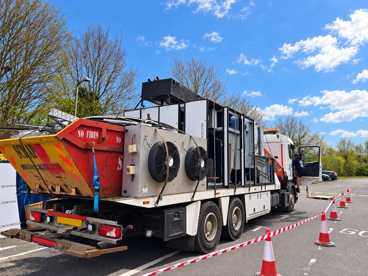 Truck carrying industrial equipment and a skip