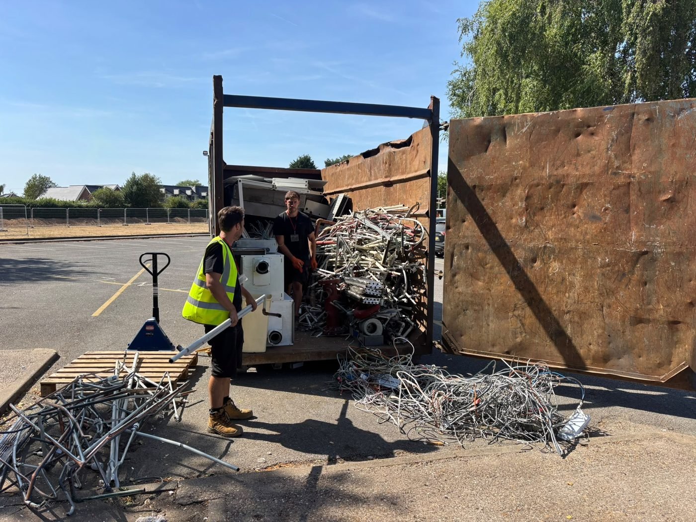 Scrap metal being unloaded from a collection truck