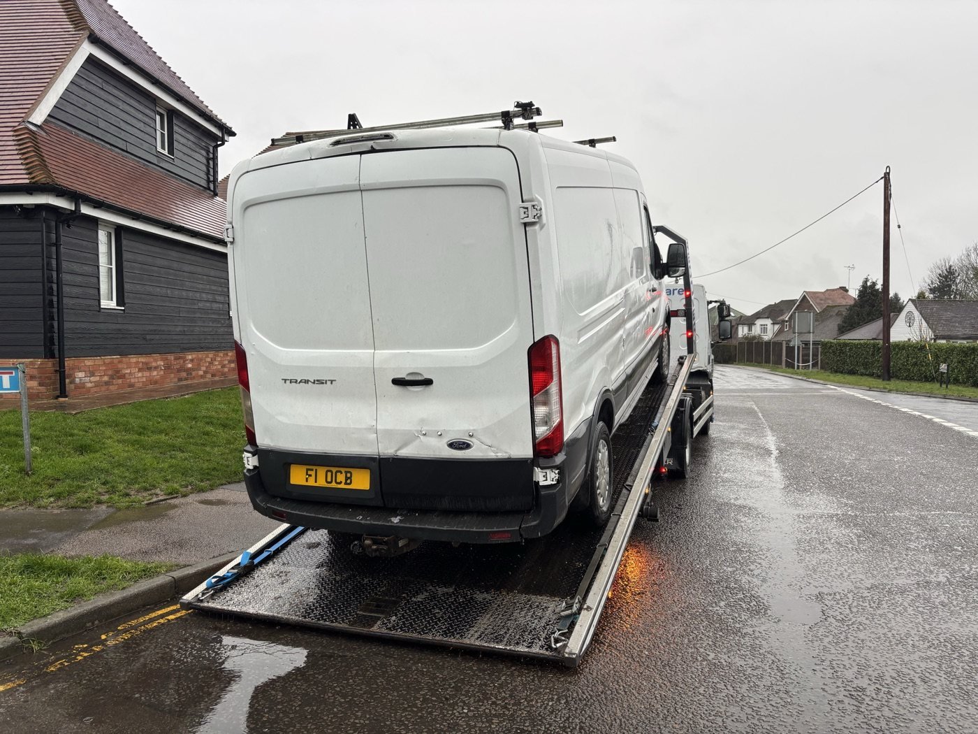 White van secured on a recovery truck